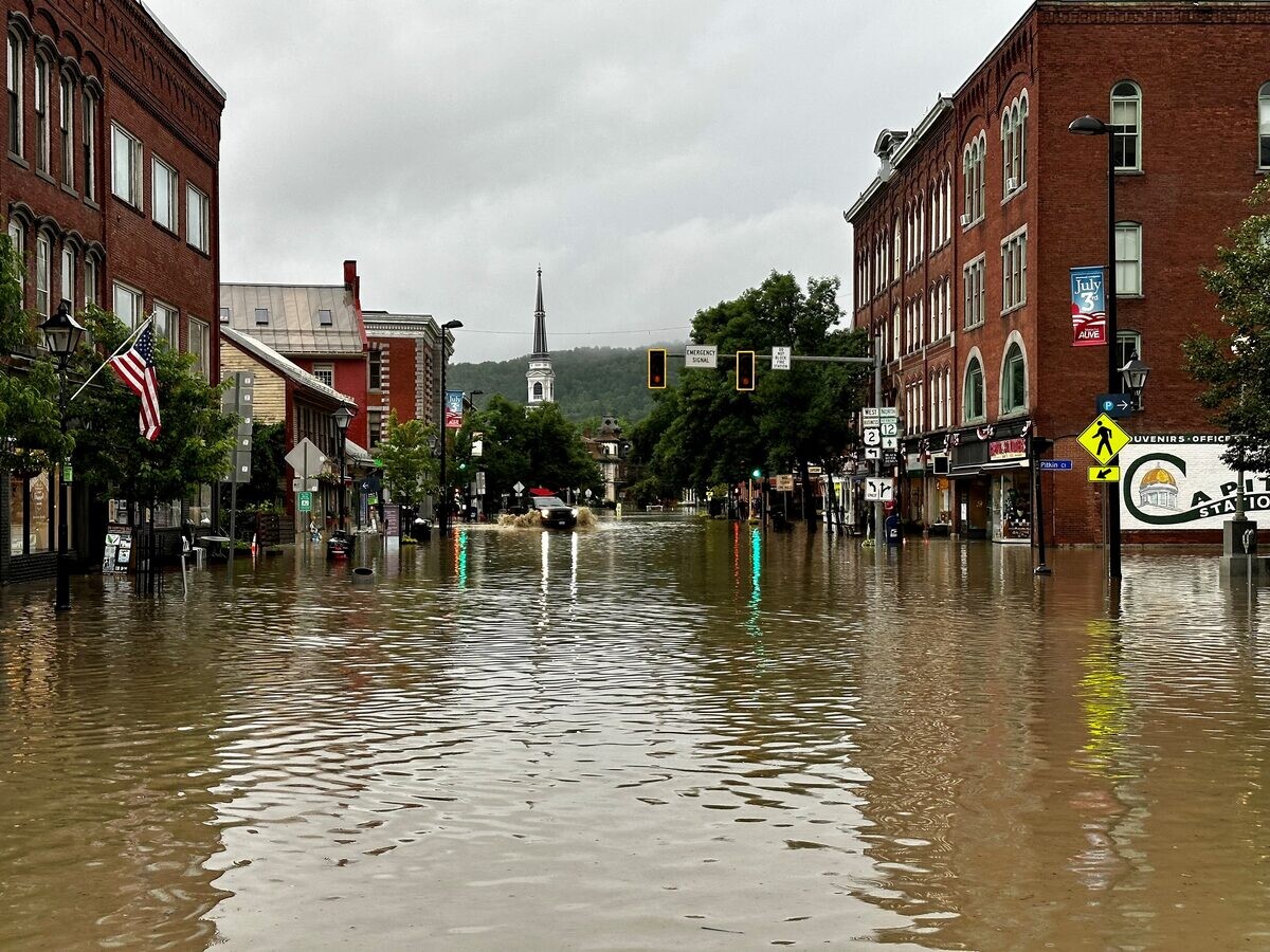 Flooded city street during extreme weather event showing the impact of climate disasters on urban infrastructure, demonstrating why off-grid battery storage is critical for emergency power resilience